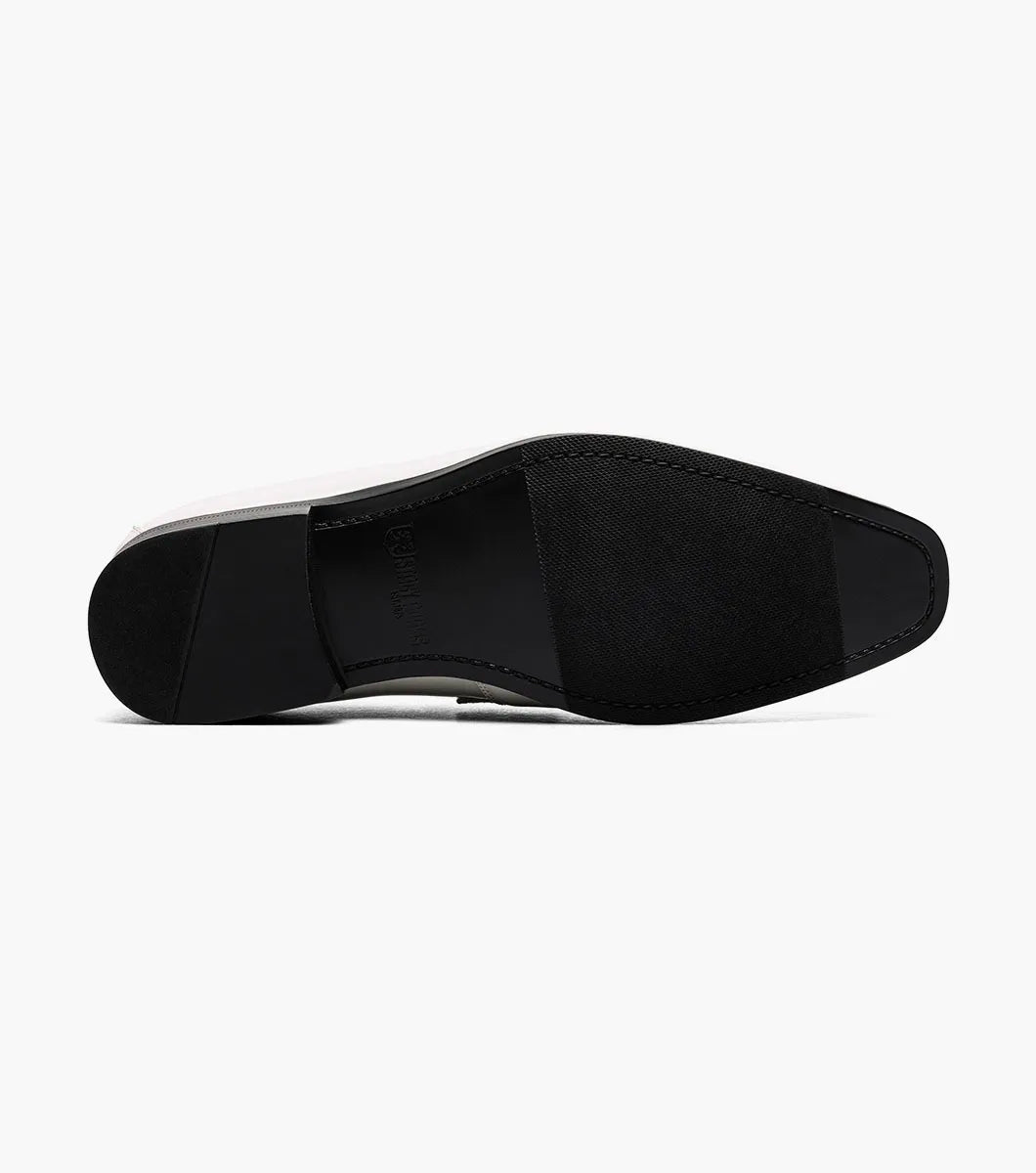 The STACY ADAMS Spratley Moc Toe Saddle Slip On in ivory features a cream velour upper with suede panel, low black heel, and almond toe for a sophisticated men's loafer.