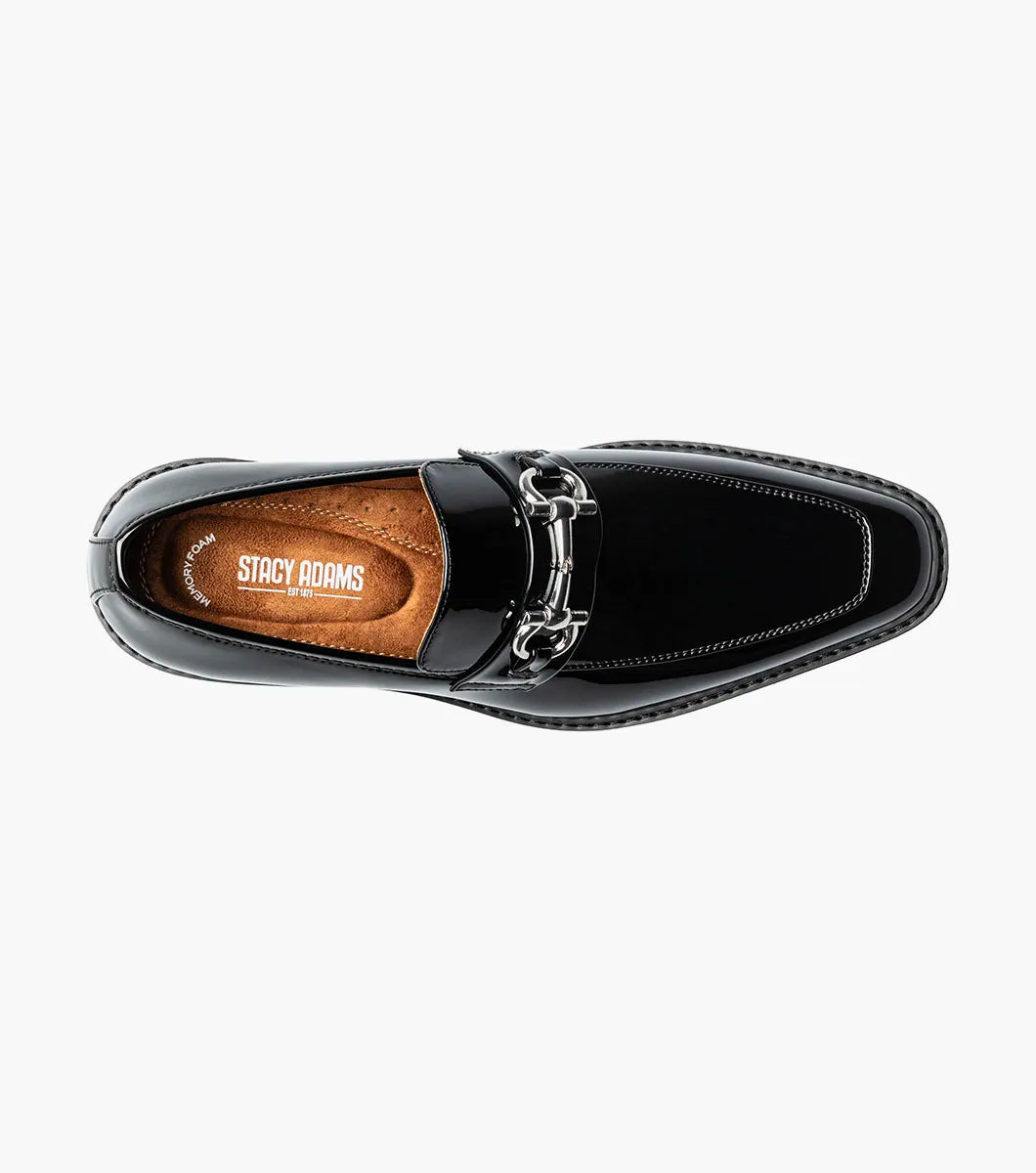 The STACY ADAMS Carabello Moc Toe Bit Slip On (Black Patent, style 25804-004) features a glossy black patent leather upper, a chunky rubber sole, and a sleek metallic bit detail across the front. Designed with a cushioned insole for added comfort, this effortlessly stylish dress shoe is displayed against a white background.