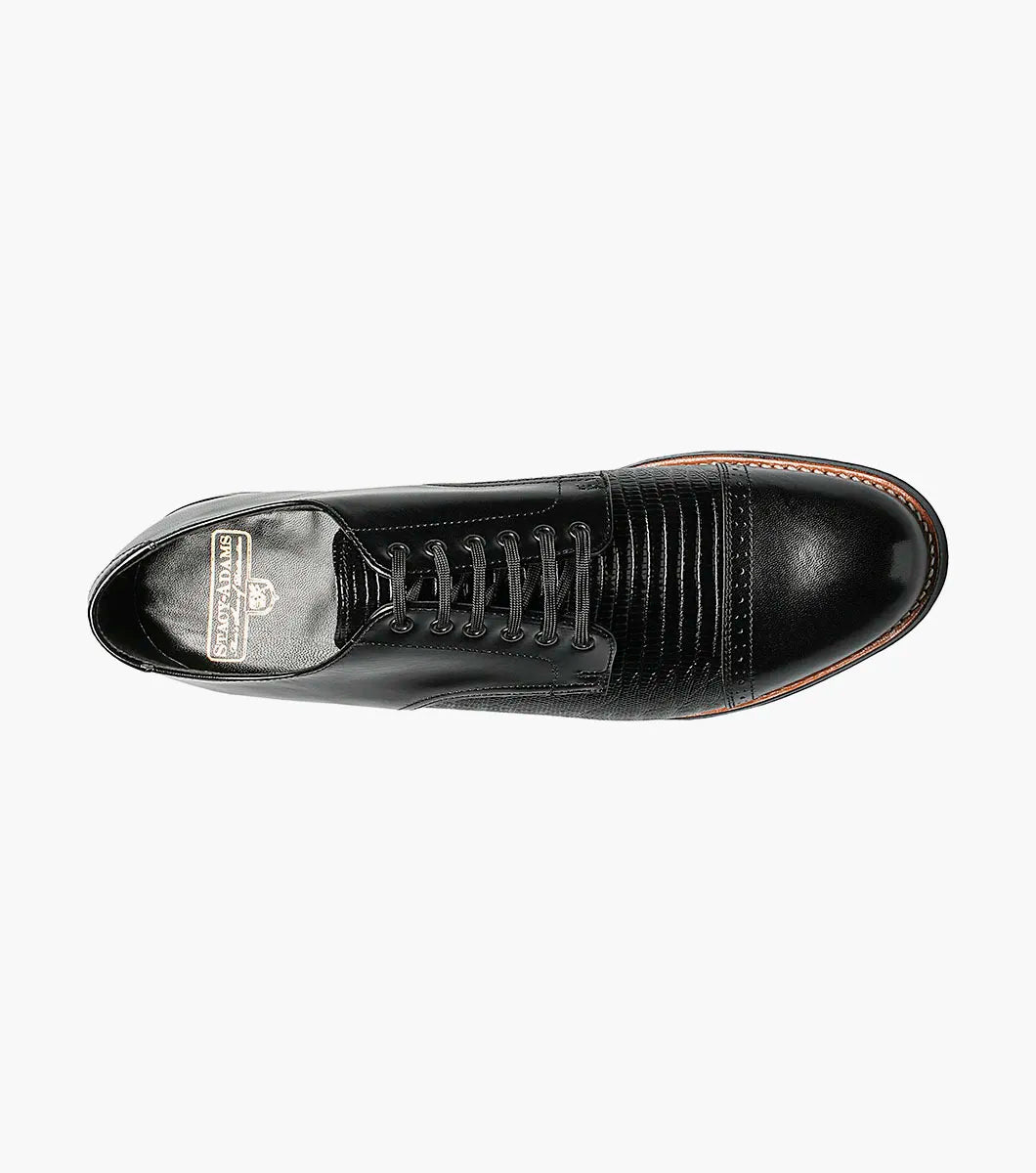 The Stacy Adams Madison Lizard Cap Toe Oxford (00049-01) is a black kidskin leather dress shoe for men, featuring a lizard print cap toe and five eyelets, shown against a white background. Brand: STACY ADAMS.