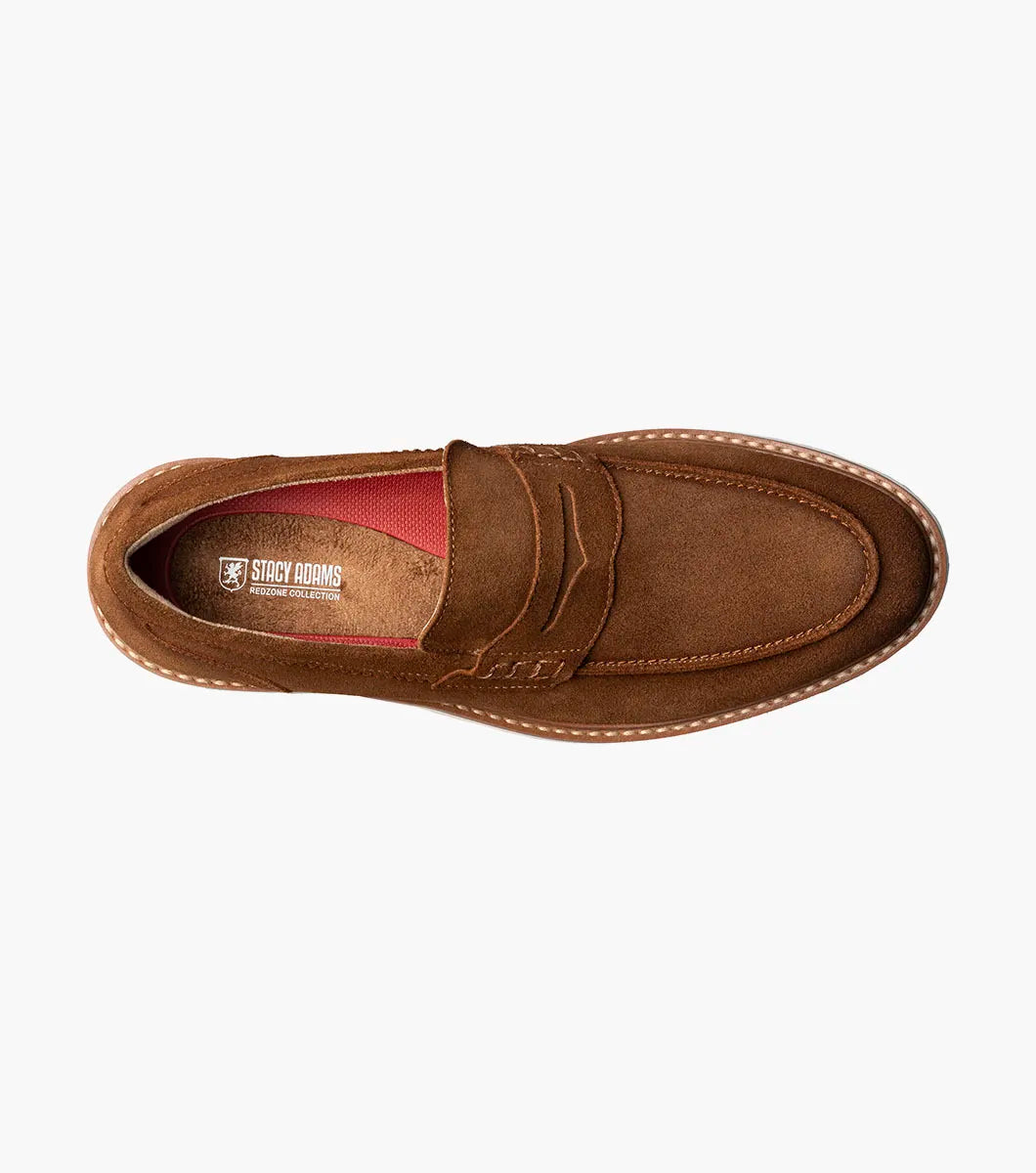 The STACY ADAMS Hopkins Moc Toe Penny Slip On in brown suede (25708-245) features a low heel, visible stitching, white rubber sole, and enhanced arch support, shown on a plain white background.