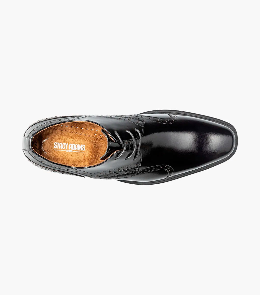 The STACY ADAMS Alexander Plain Toe Oxford in black (style 25791-001) is an elegant calf leather dress shoe with laces, decorative perforations, a low heel, and a comfortable memory foam insole, displayed on a light background.