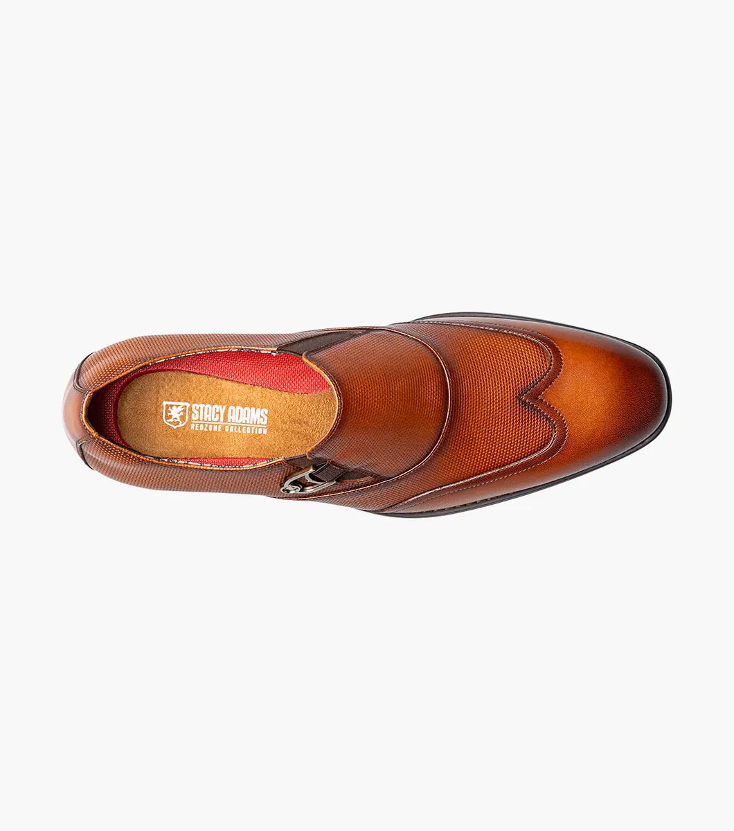 The Stacy Adams Lockwood Wingtip Ornament Slip On in Cognac features classic leather style with a textured upper, single side buckle, and low stacked heel—perfect for men seeking timeless dress shoes.