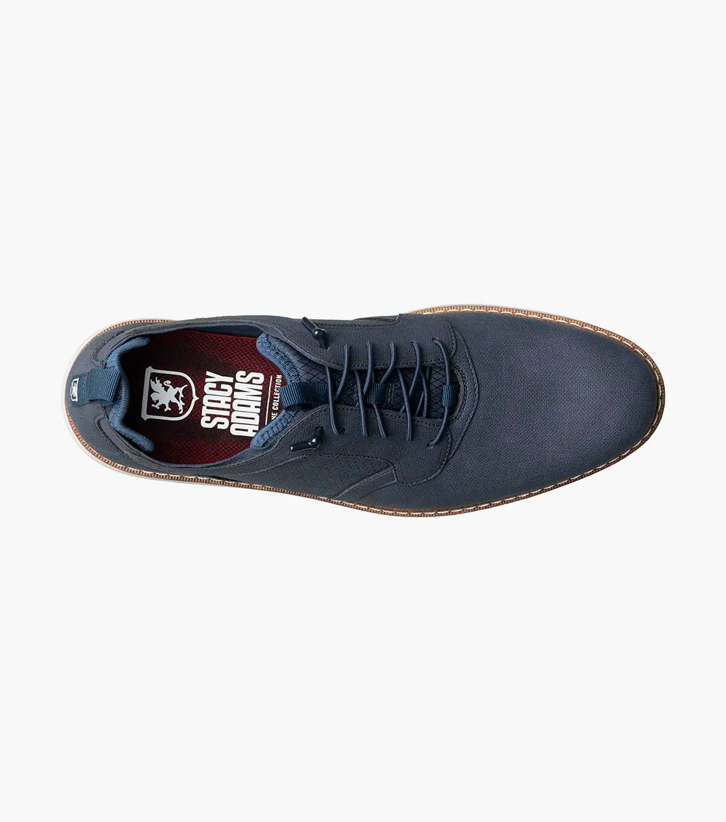 The STACY ADAMS Score Plain Toe Elastic Lace Up in navy (style 21538-410) is a blue dress shoe with elastic laces, featuring a perforated side panel, tan stitching, and a light-colored sole on a white background. It includes anatomical arch support for enhanced comfort.