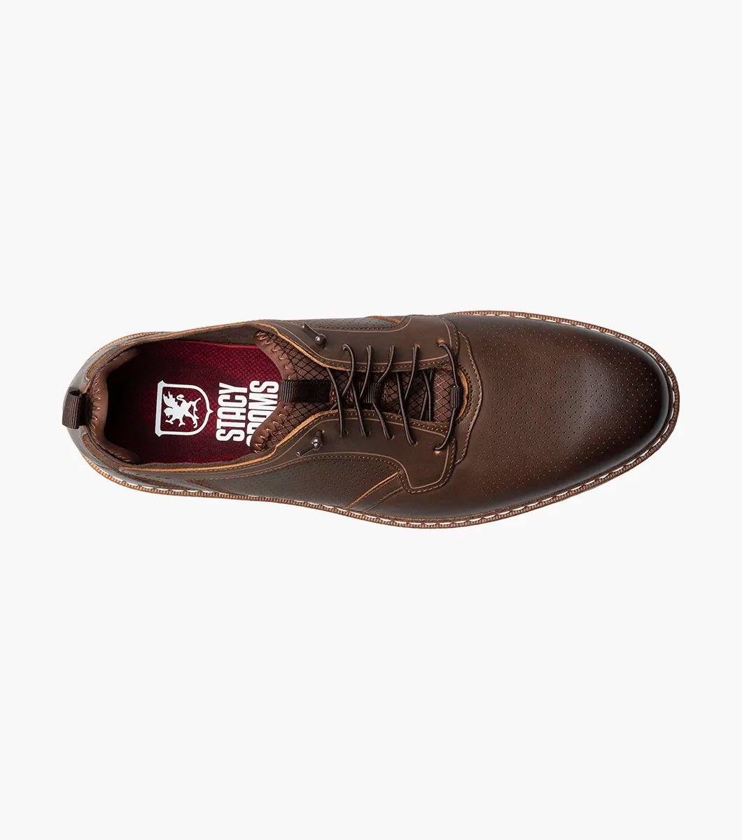 The Stacy Adams Sync Plain Toe Elastic Lace Up in brown features a leather upper, white sole, perforated details, and low-top design for all-day comfort. Shown on a plain white background. Brand: STACY ADAMS. Style: 25662-215.