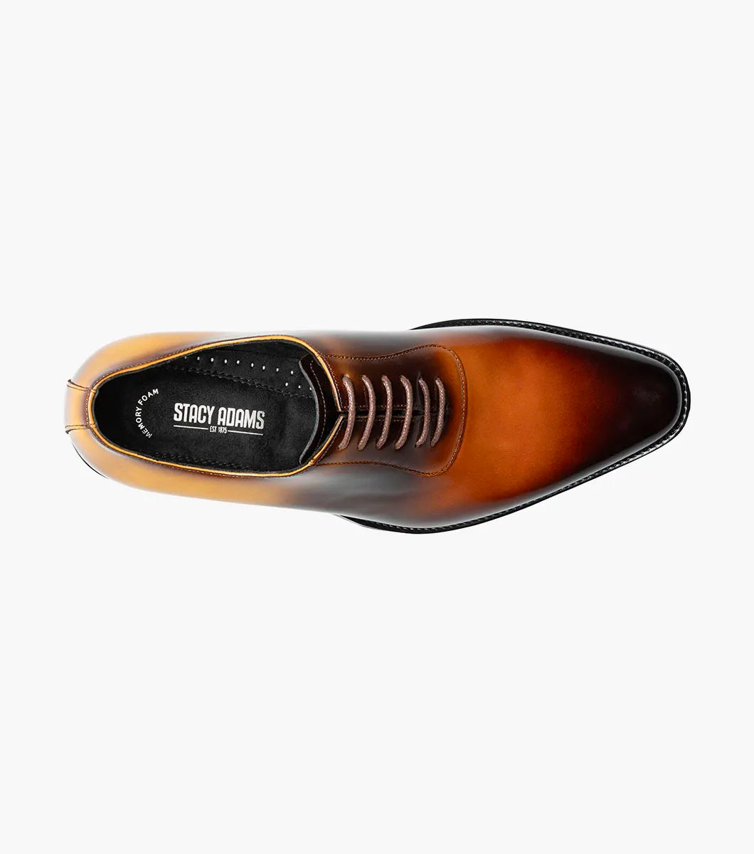 The STACY ADAMS Shaffer Plain Toe Oxford in Cognac Multi (25763-229) features calf leather with a brown-yellow gradient, laces, a low heel, memory foam insole, and polished finish, displayed on a white background.