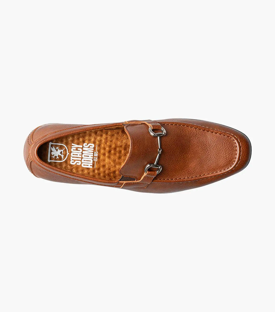 The STACY ADAMS Richmont Moc Toe Bit Slip On in Cognac Tumbled (21567-222) is a brown leather loafer with a metal bit, moc toe slip-on design, low wooden heel, and detailed toe stitching, shown on a white background.