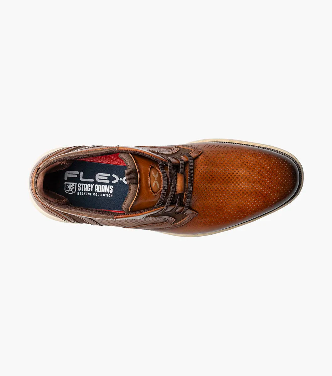 The Stacy Adams Eastmont Plain Toe Elastic Lace Chukka Boot in cognac features a perforated design, light tan rubber sole, and anatomical arch support for all-day comfort, shown on a white background.