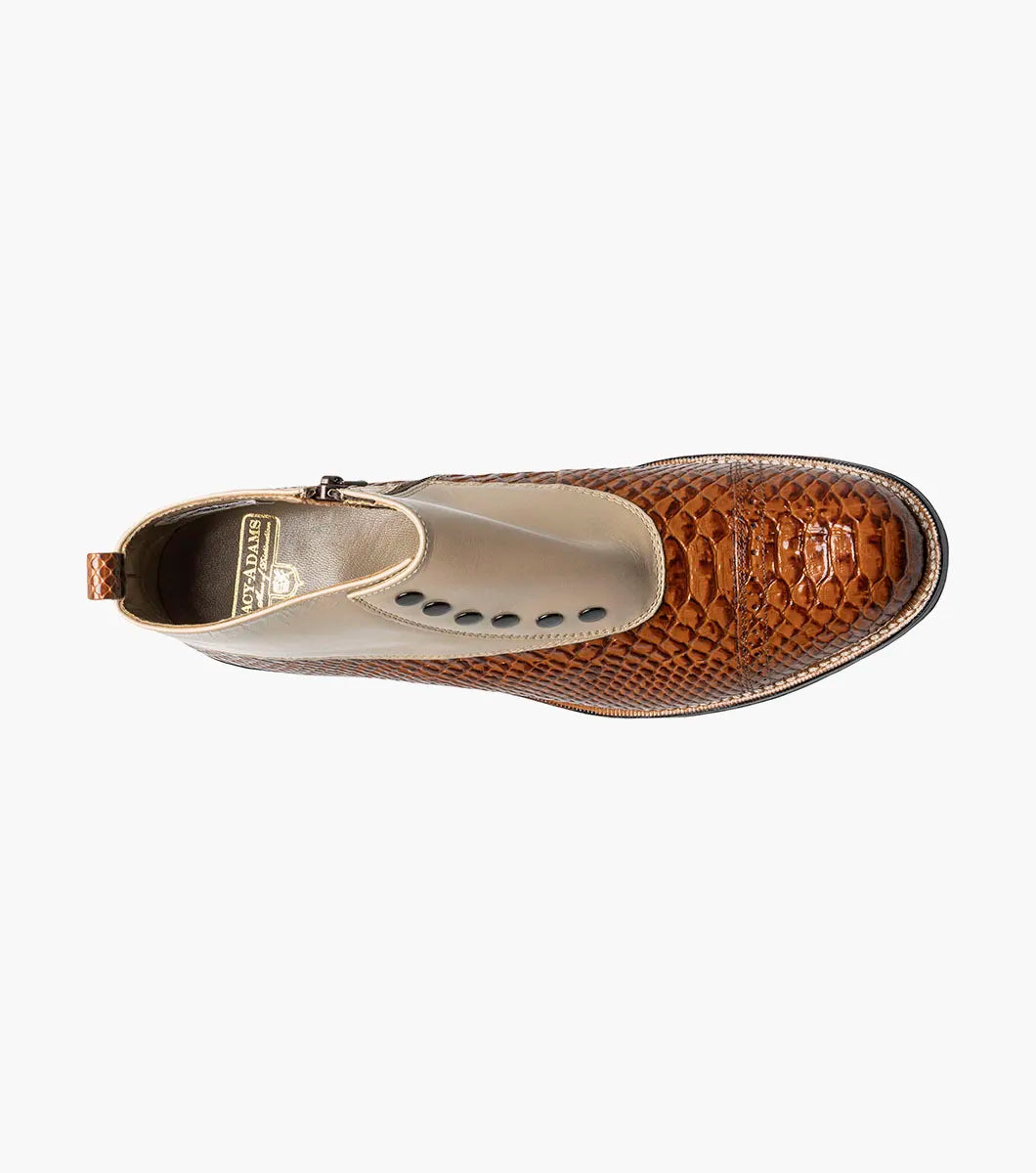 The Stacy Adams Madison Spectator Spat Cap Toe Demi Boot in Tan Multi (00109-238) features a brown and tan ankle boot design with black buttons, a textured reptile-like lower portion, and smooth kidskin leather on the upper section, crafted in STACY ADAMS’ distinctive spectator boot style.
