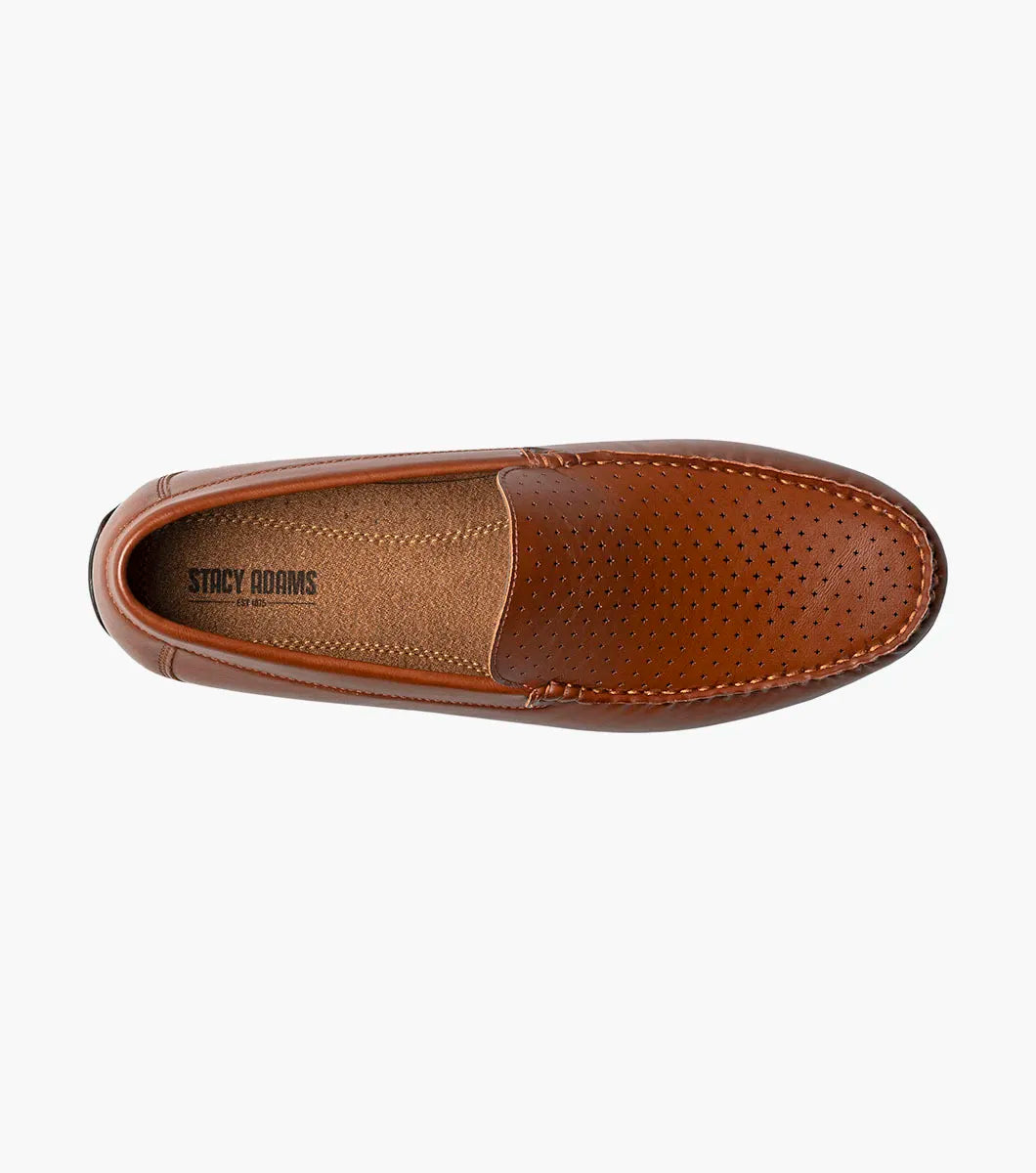 The STACY ADAMS Conroy Moc Toe Perf Slip On in Cognac (25702-221) is a brown leather loafer with a perforated upper, black sole, moccasin-style stitching, and cushioned footbed, shown side profile on a white background.