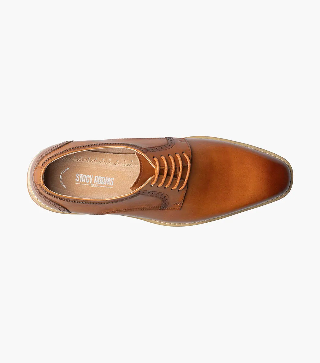 The STACY ADAMS "Barringer Plain Toe Oxford" in tan (25722-240) is a brown leather lace-up dress shoe with a low heel, white rubber sole, and Memory Foam footbed for comfort, shown against a plain white background.