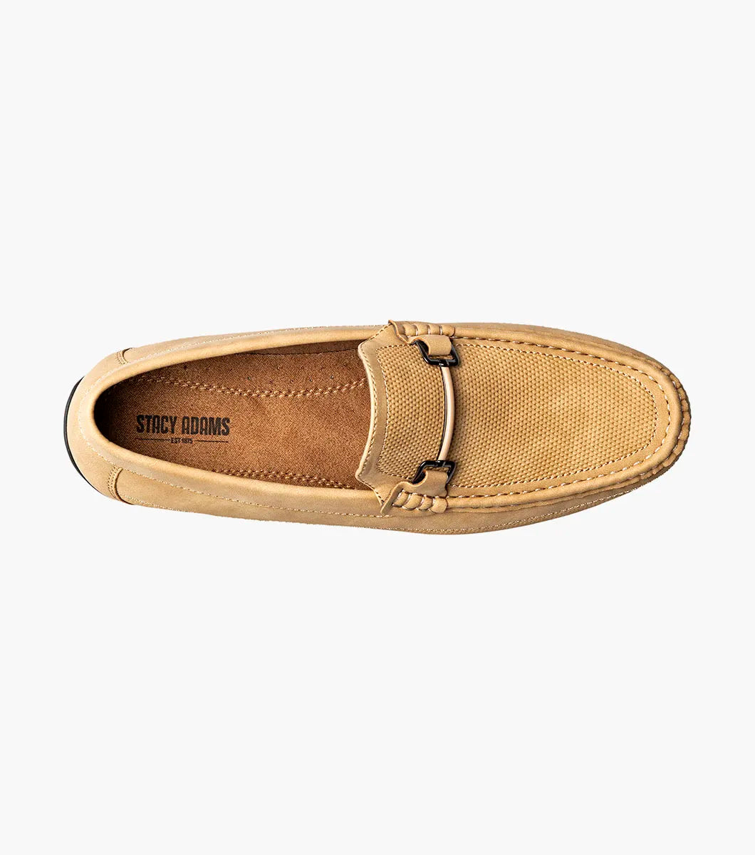 The Stacy Adams Colton Moc Toe Bit Slip On in khaki features a stitched moc toe, metal bit detail, black rubber sole, multicolored striped lining, and cushioned footbed for all-day comfort.