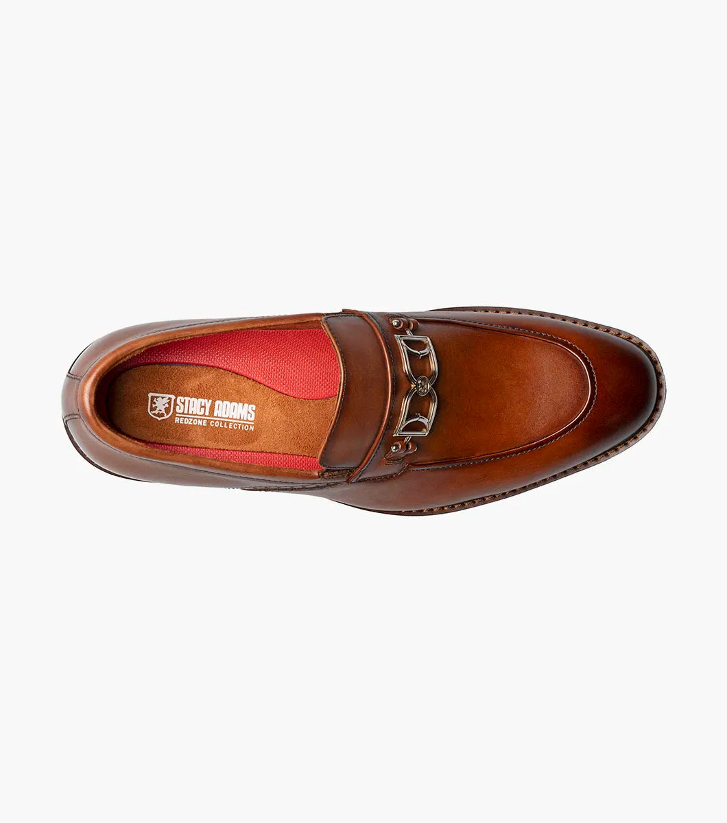 The Stacy Adams Boyd Moc Toe Bit Slip On in Brandy features a brown leather upper, moc toe design, metal horsebit detail, low heel, cushioned footbed, and visible stitching. Model 25753-226 by STACY ADAMS shown on a white background.