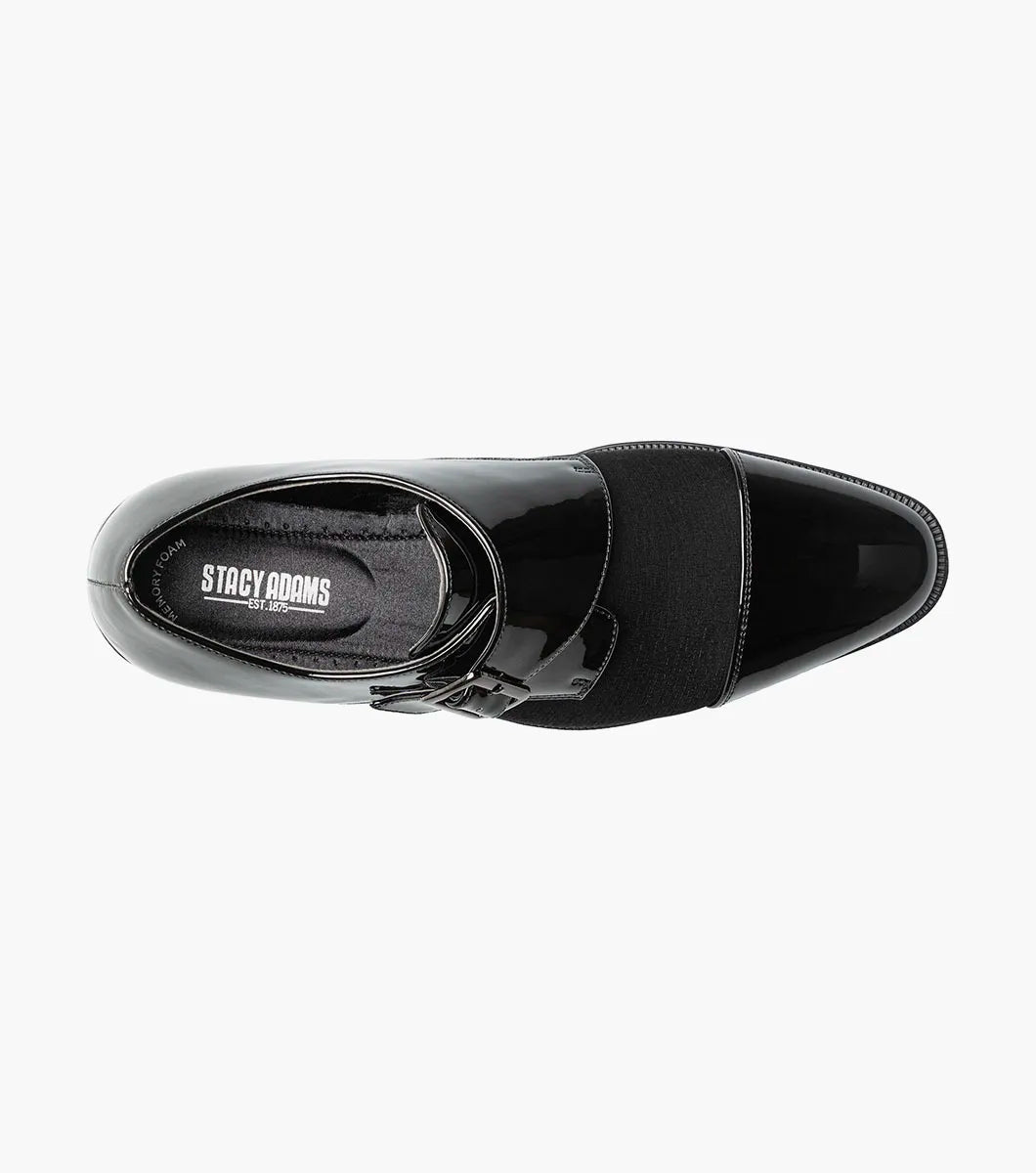 The STACY ADAMS Sutherland Cap Toe Monk Strap in black (style 25793-001) is a formal leather dress shoe with a glossy cap toe, single side buckle, and low heel, shown against a plain white background. These monk strap shoes are designed for all-day comfort with a memory foam insole.
