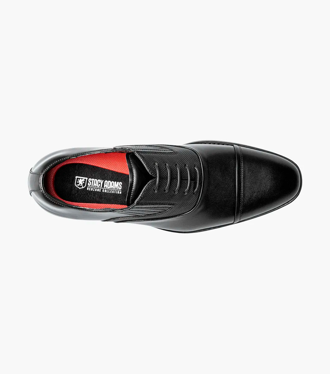 The STACY ADAMS Lucas Cap Toe Oxford (25766-001) is a black leather men's dress shoe with textured side panels, black laces, and a supportive RedZone footbed, shown on a plain white background.