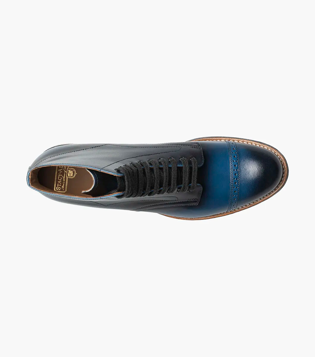 The STACY ADAMS Madison Cap Toe Lace Up Boot in blue (00110-400) is a leather dress boot with a cap toe and brogue detailing, displayed on a white background.