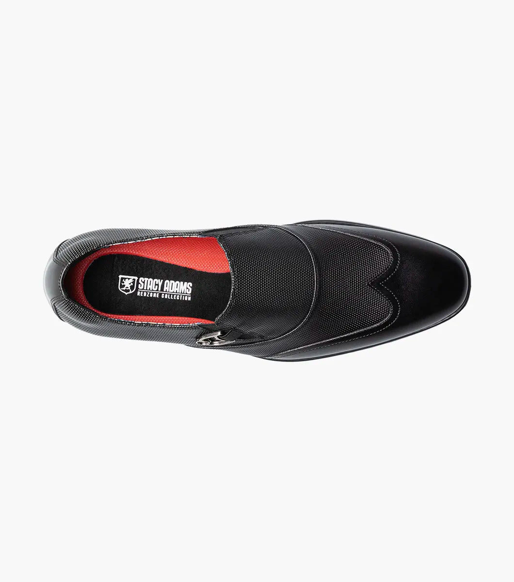 The STACY ADAMS Lockwood Wingtip Ornament Slip On in black (25767-001) features a textured upper, wingtip design, and is displayed on a white background.