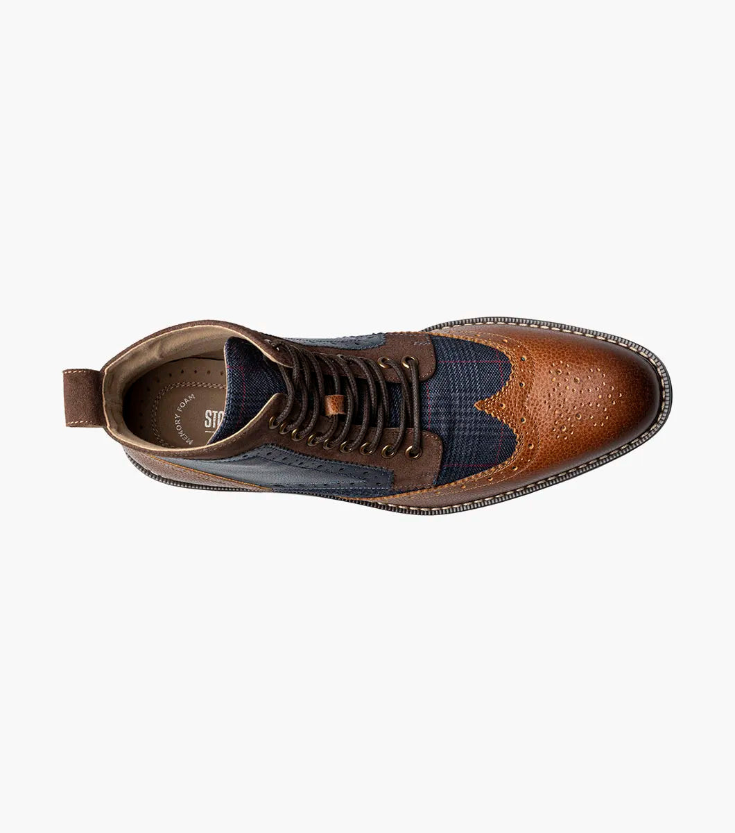 The STACY ADAMS Finnegan Wingtip Lace Up Boot (Cognac with Navy, 25427-470) features two-tone leather, brogue details, and a low heel—ideal for those seeking stylish and comfortable footwear. Shown in left profile on a white background.