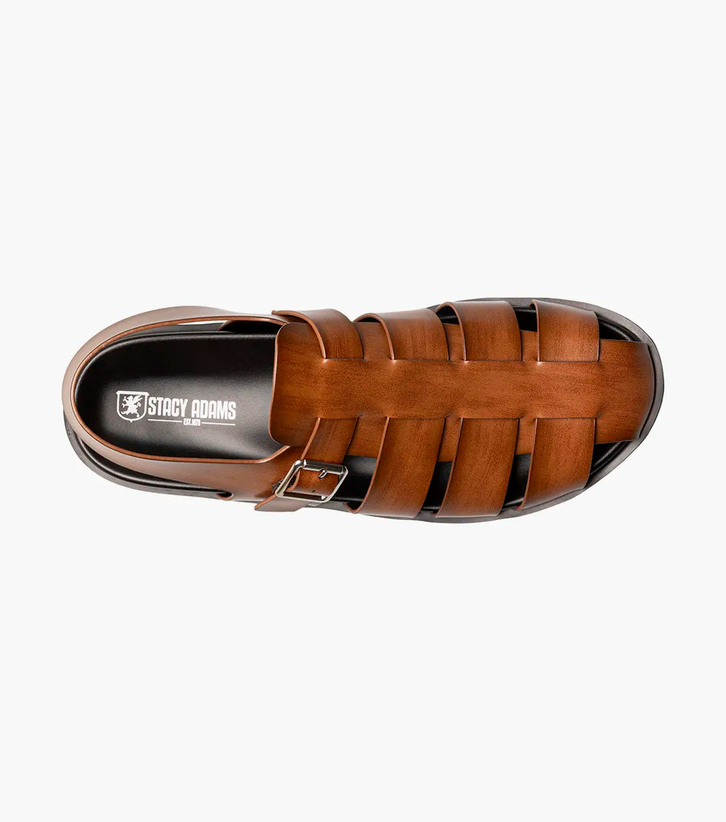 The STACY ADAMS Montego Slingback Buckle Sandal in Cognac (25659-221) features brown leather, a burnished finish, silver buckle, and black sole with EVA midsole, shown in side profile on a plain white background.