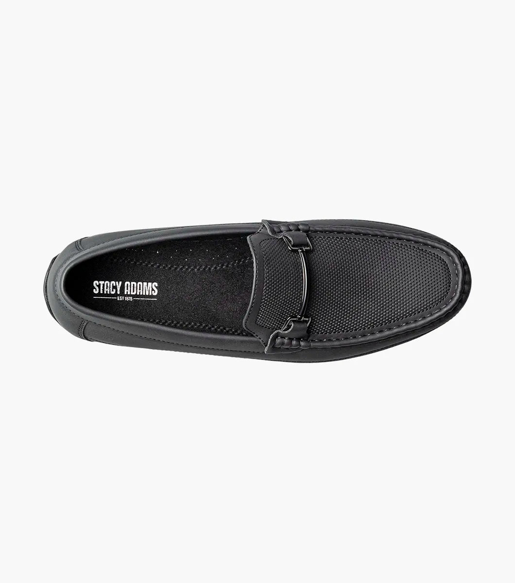 The STACY ADAMS Colton Moc Toe Bit Slip On in black (25760-001) features textured leather, cushioned footbed, metal bit accent, and striped inner lining, shown on a white background.