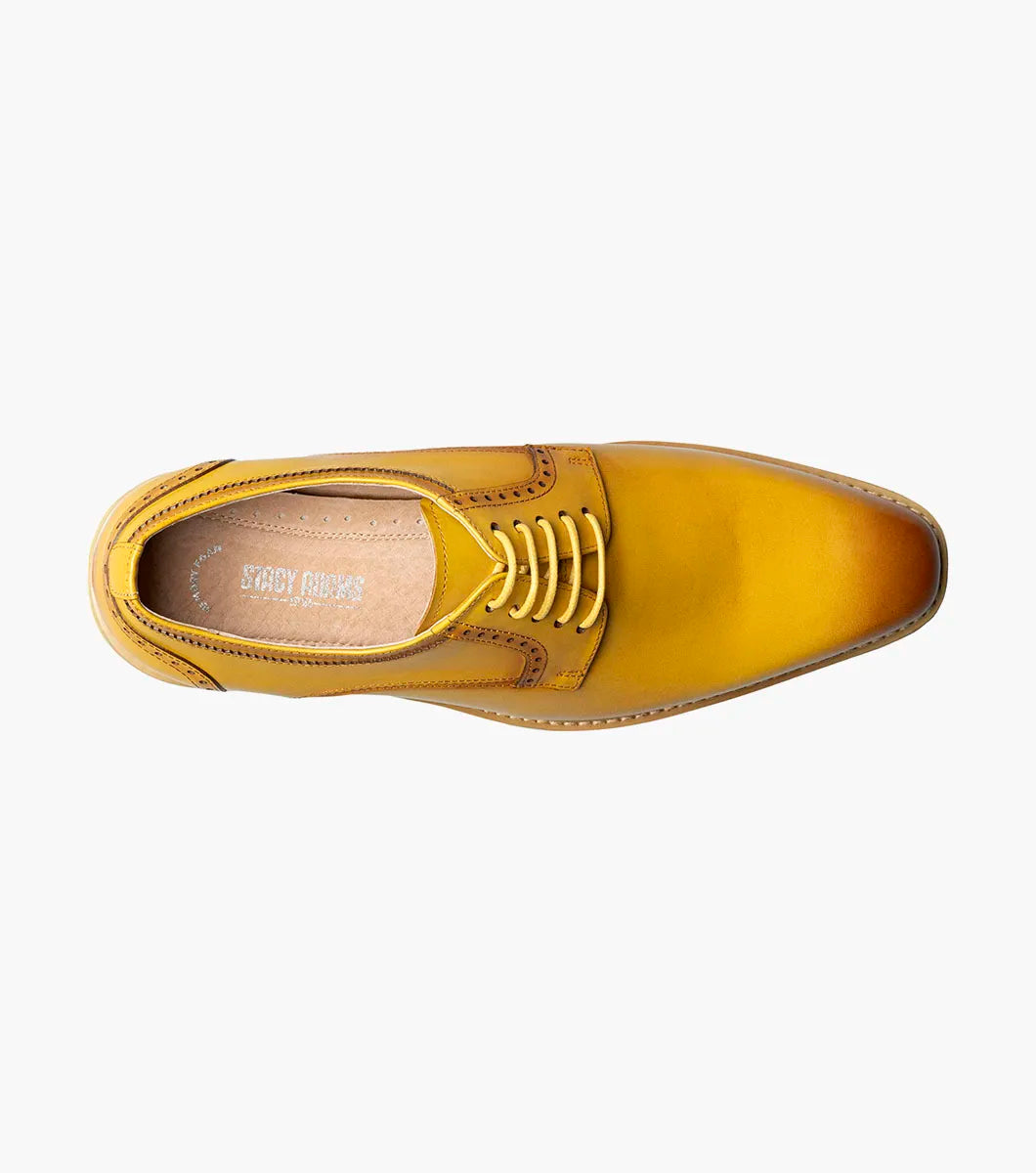The Stacy Adams Barringer Plain Toe Oxford (25722-700) is a yellow leather lace-up dress shoe with a durable rubber outsole and white and tan sole, shown in a side profile against a white background.