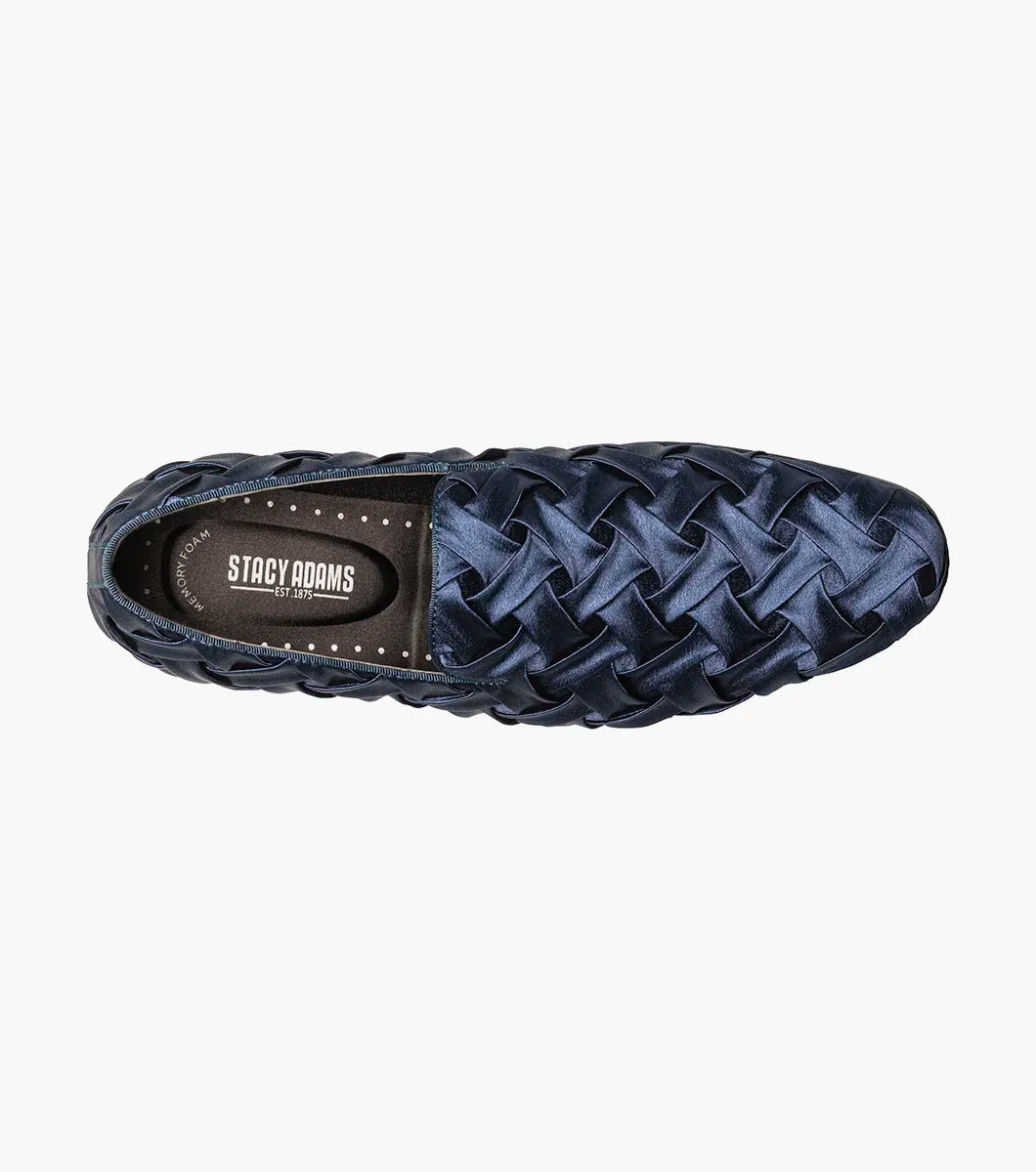 The STACY ADAMS Savoir Plain Toe Satin Slip On (Navy, 25611-410) is a men's loafer with a glossy woven satin design, low black heel, and memory foam insole, shown on a white background.