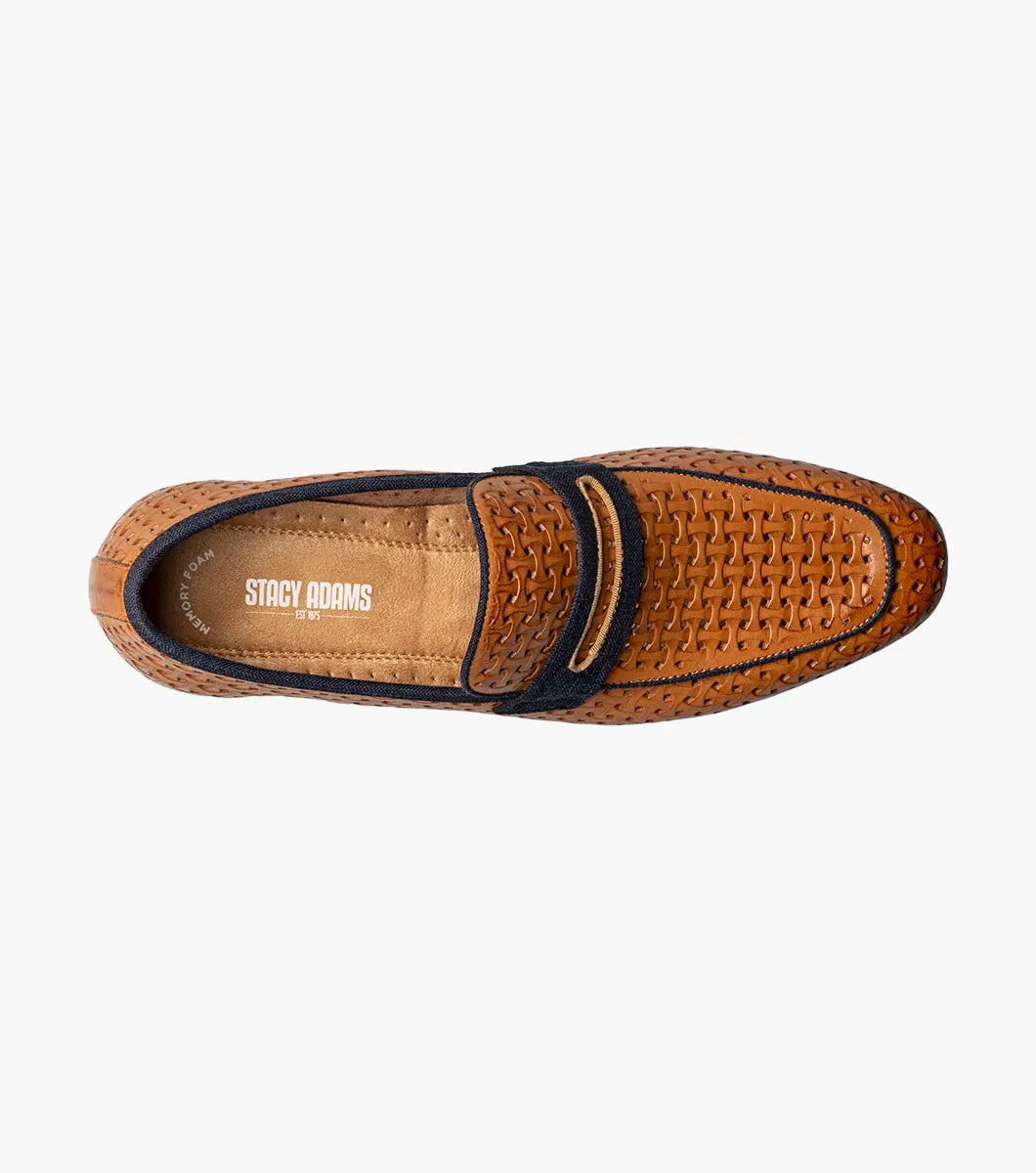 The STACY ADAMS Winstead Moc Toe Saddle Slip On in Natural features a brown woven leather upper, dark blue trim, Memory Foam insole, and low heel, displayed on a white background.
