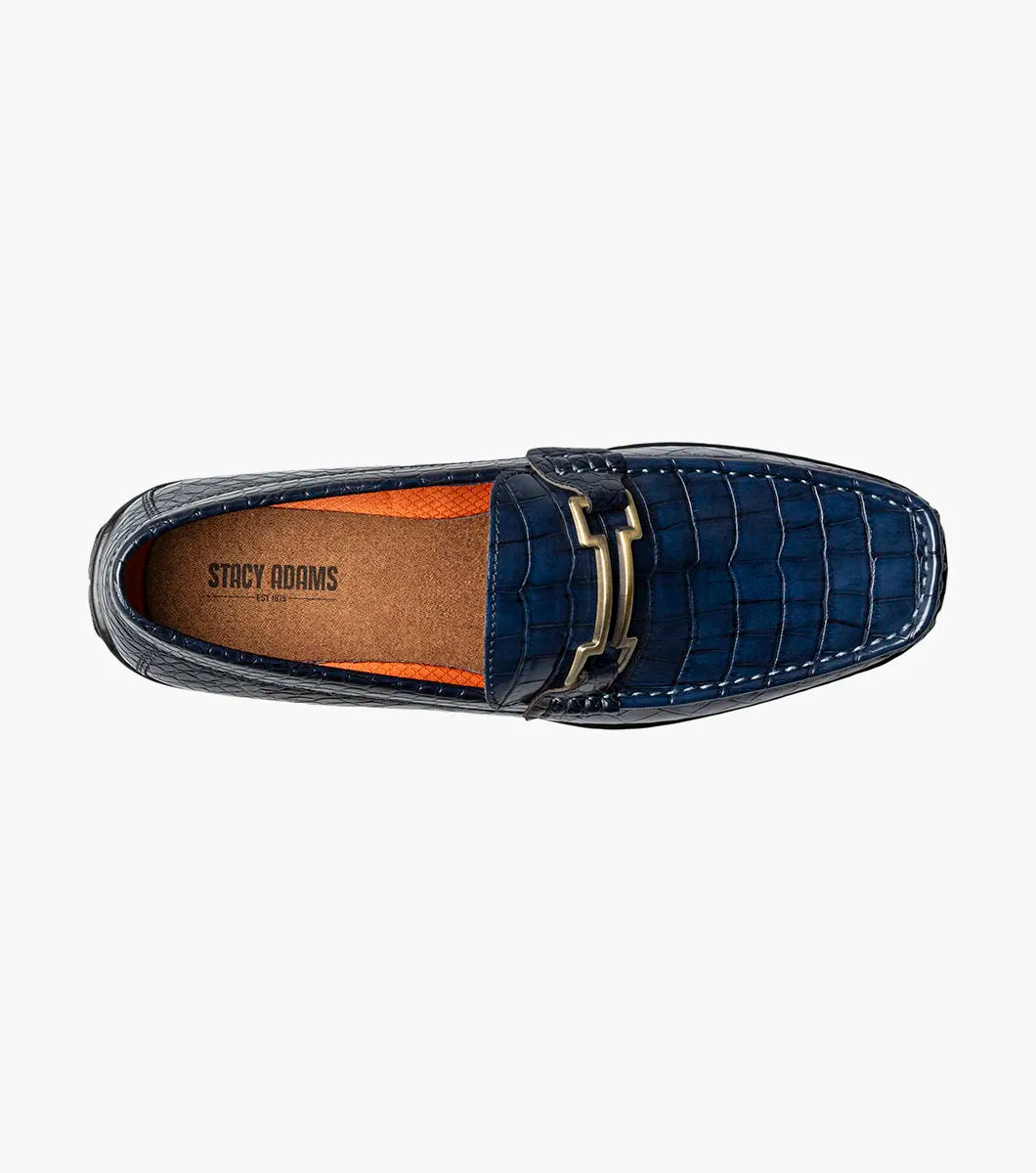The Stacy Adams Embrey Moc Toe Bit Slip On in navy features crocodile print, a cushioned footbed, black sole, and metal bit detail on the upper, displayed side view on a white background.