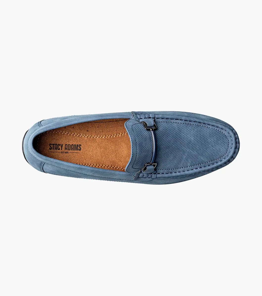 The STACY ADAMS Colton Moc Toe Bit Slip On (Navy, 25760-410) features a cushioned footbed, metal bit detail, moc toe stitching, and a flat black sole, shown on a white background.