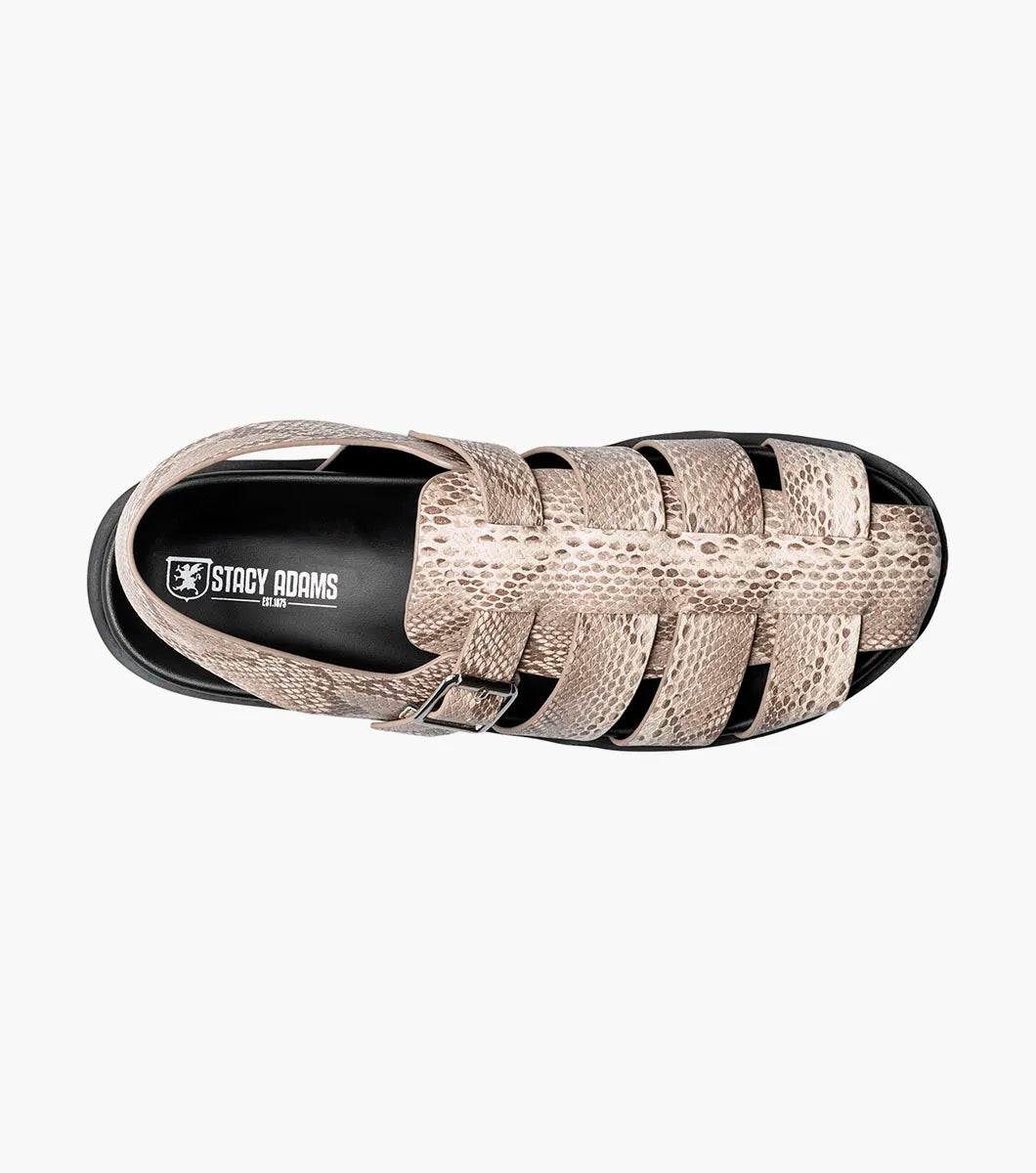 The Stacy Adams Montego Slingback Buckle Sandal (Sand, 25659-269) features a tan snakeskin pattern, closed toe, cutout sides, adjustable buckle strap, black sole, and cushioned EVA midsole on a white background.