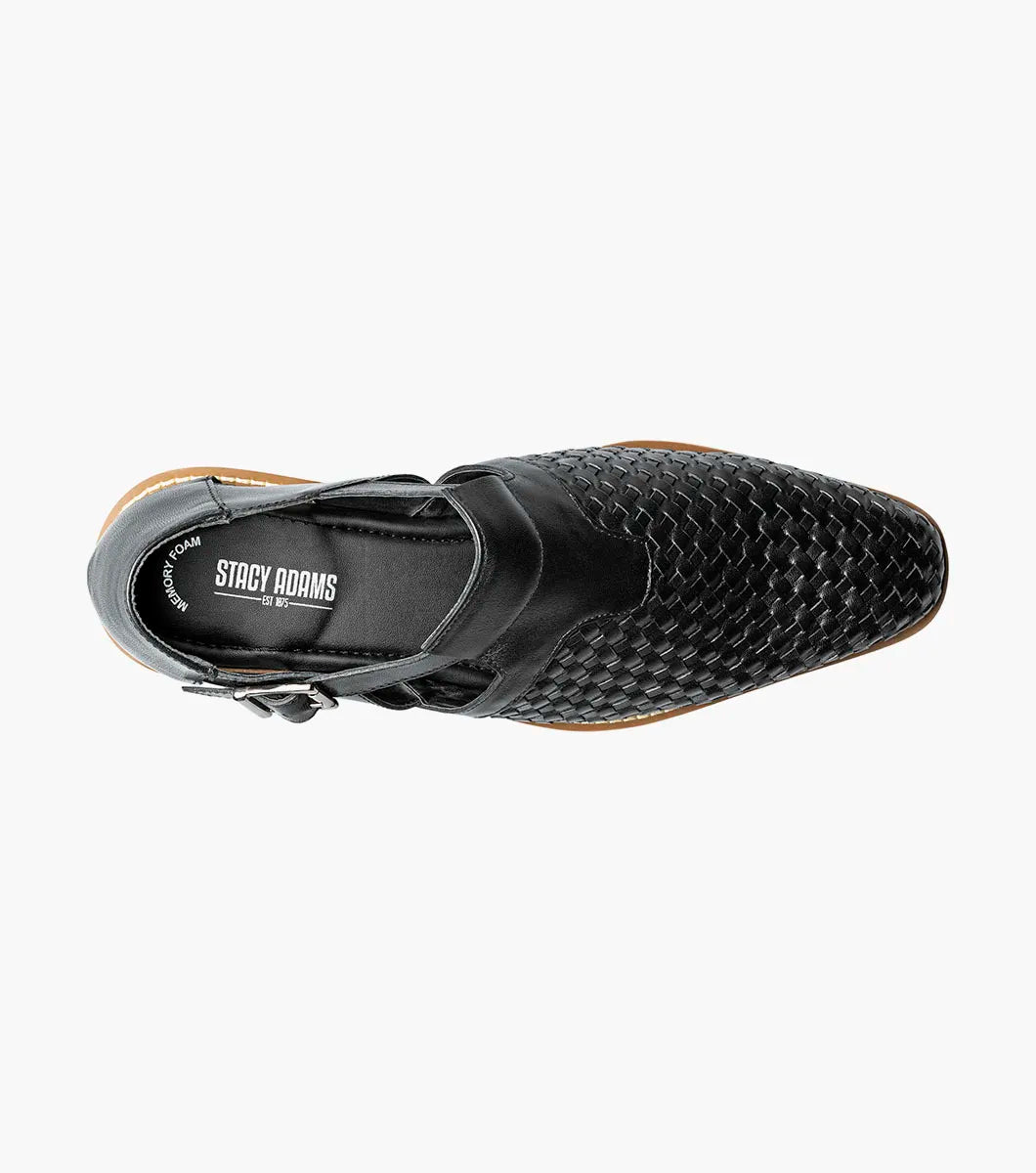 The Stacy Adams Alvarado Woven City Sandal features a black woven leather upper, buckle strap, closed toe, memory foam insole, and a white ridged sole with tan accent.