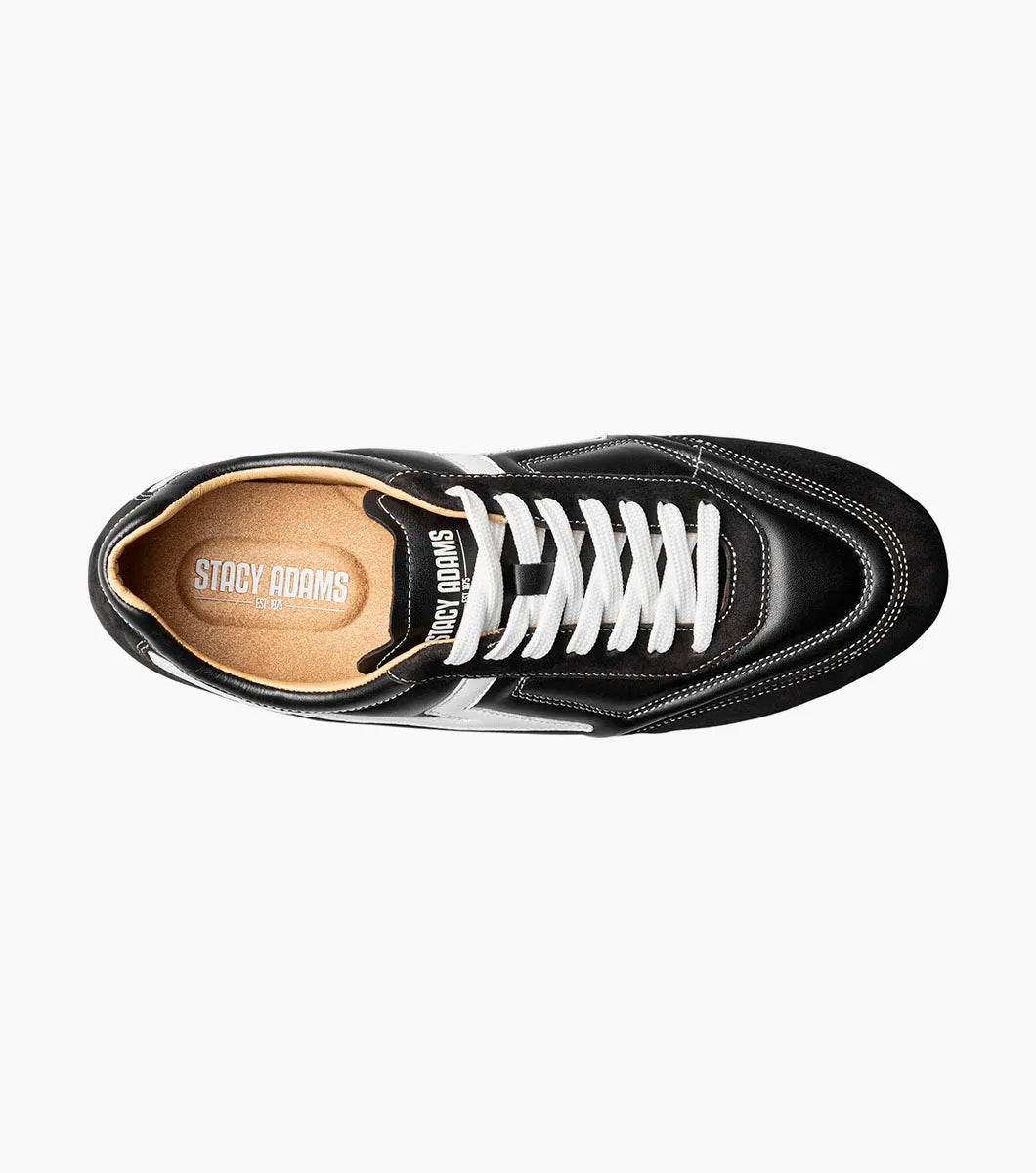 The Stacy Adams - Action 150 Sporty Lace Up sneaker (style 25797-001) is a black, low-top shoe featuring white laces, sporty lace-up design, distinctive white side detailing, and a brown rubber sole. It is shown in a side profile view on a plain white background.