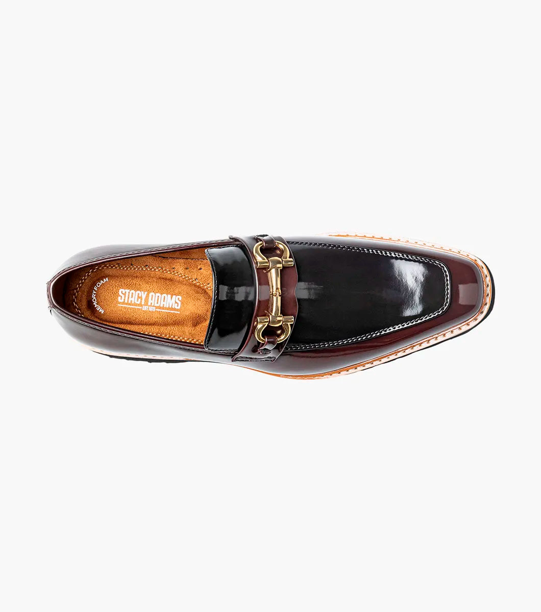 Introducing the Stacy Adams Carabello Moc Toe Bit Slip On in Burgundy Multi (style 25804-641): This STACY ADAMS loafer showcases a glossy two-tone upper in black and burgundy, accented with gold hardware across the front, a tan interior lining, and a chunky black sole. The moc toe bit design also features a plush memory foam insole for exceptional comfort.