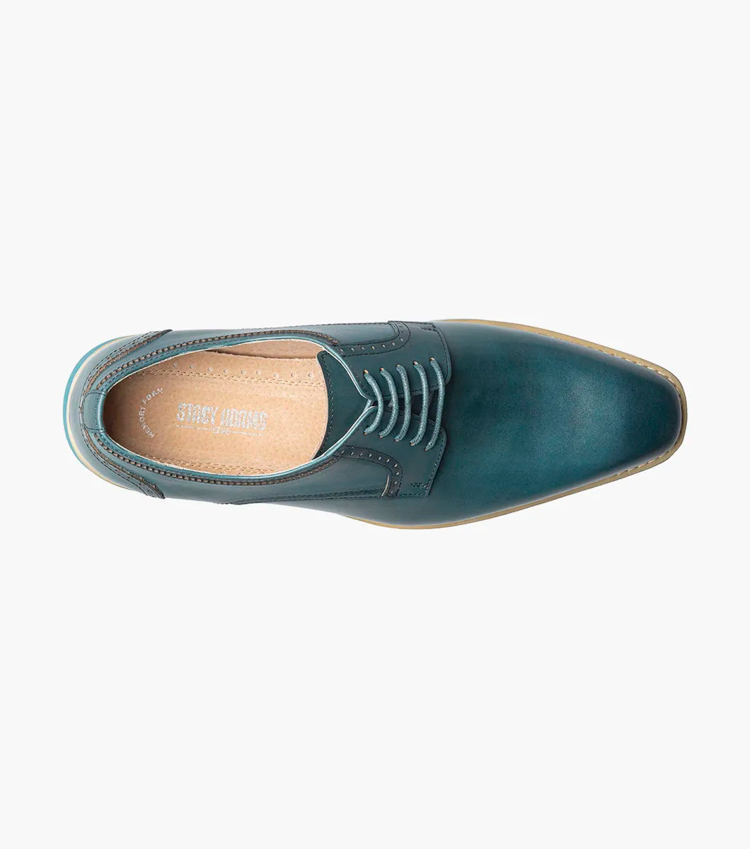 The Stacy Adams Barringer Plain Toe Oxford (Teal, 25722-444) features a rounded toe, tan welt, decorative stitching, leather upper, cushioned insole, and white rubber sole. Shown solo against a plain white background.
