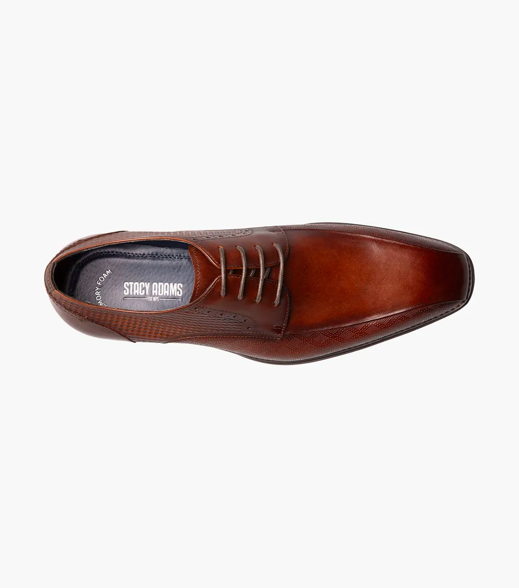 The Stacy Adams Simmons Bike Toe Oxford in Cognac (25674-221) features brown leather with side and front texture, laces, a low heel, polished finish, and a comfortable Memory Foam insole, shown on a plain white background.