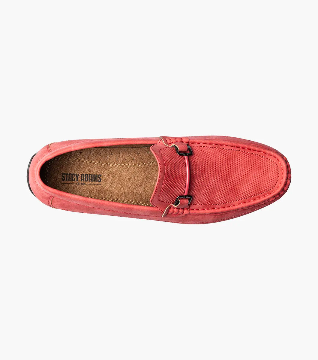 The Stacy Adams Colton Moc Toe Bit Slip On (25760-600) is a red suede loafer featuring a metal bit detail, visible stitching, black sole, striped inner lining, and cushioned footbed for comfort.