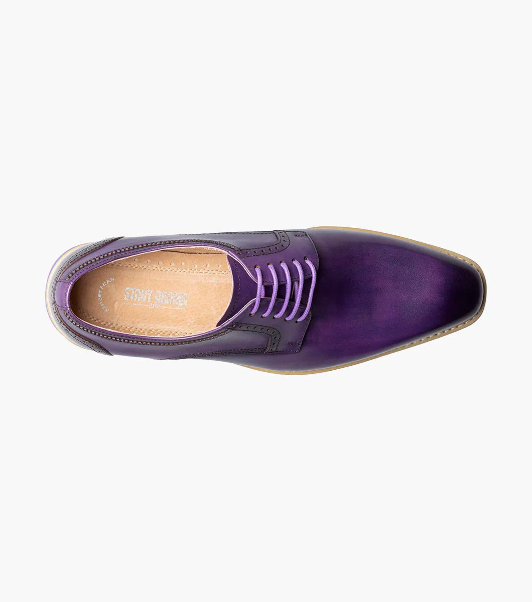 The STACY ADAMS Barringer Plain Toe Oxford (Purple, 25722-542) is a single purple leather lace-up dress shoe with a low heel, contrasting sole, and Memory Foam footbed, shown on a plain white background.