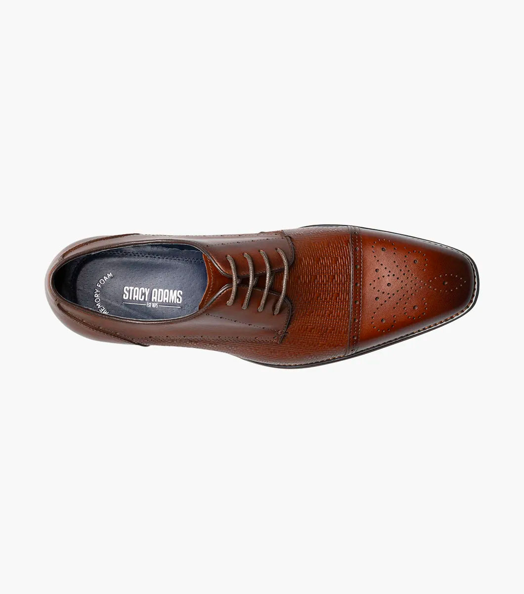 The Stacy Adams Silsbury Cap Toe Oxford in Cognac features decorative toe perforations, textured upper detailing, lace-up closure, low heel, and a memory foam footbed for comfort.