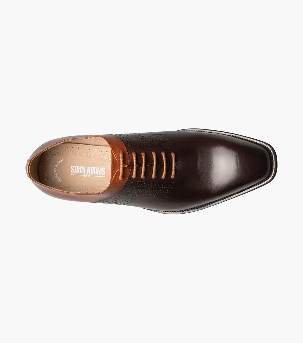 The Stacy Adams Halloway Plain Toe Oxford in Brown Multi features perforated detailing, closed lacing, a low wooden heel, and a cushioned Memory Foam insole. Shown on a plain white background.