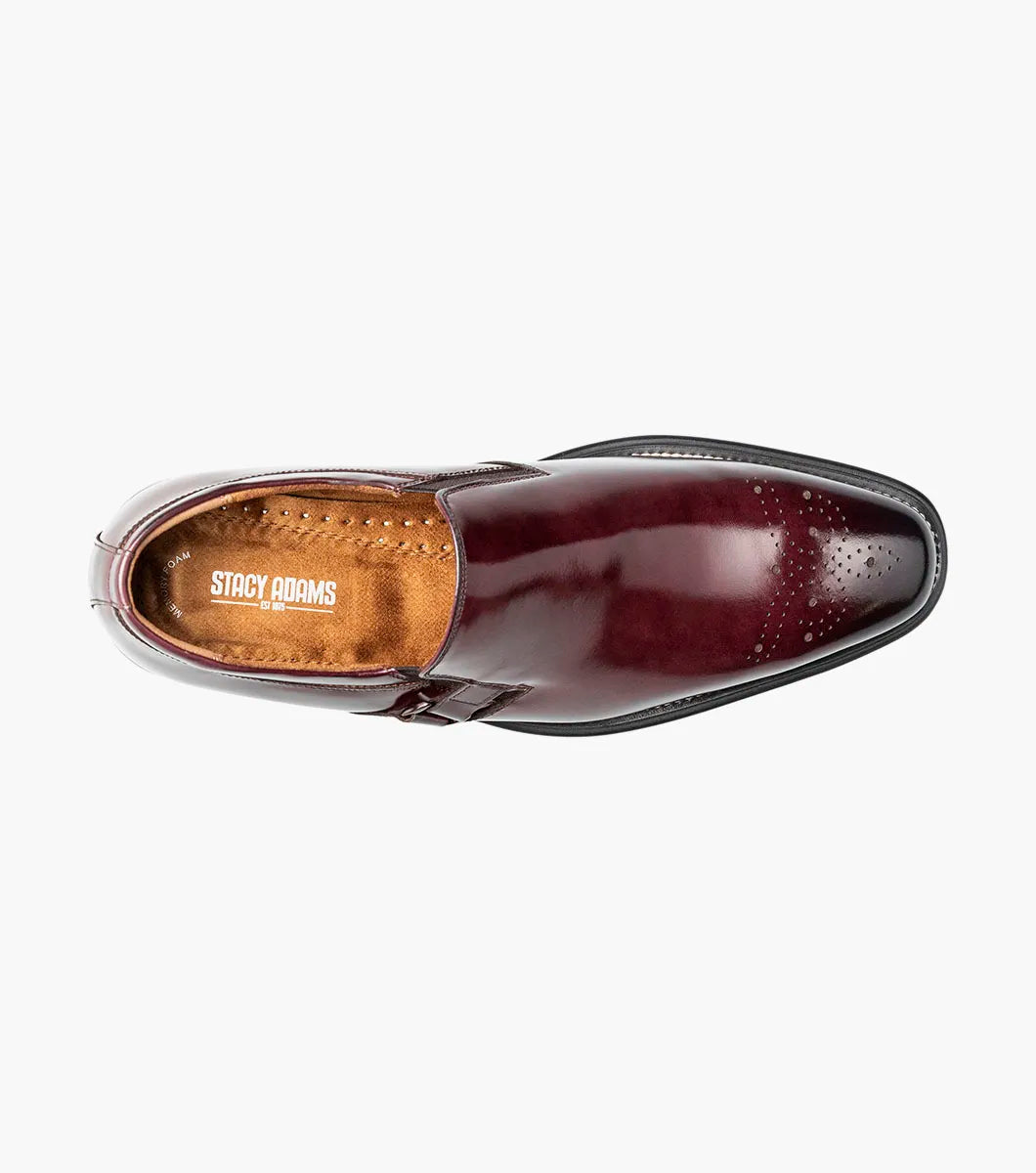 A single STACY ADAMS Alistair Plain Toe Ornament Slip On dress shoe in burgundy, featuring a side buckle detail, perforated toe design, and a comfortable memory foam insole, is displayed on a white background.