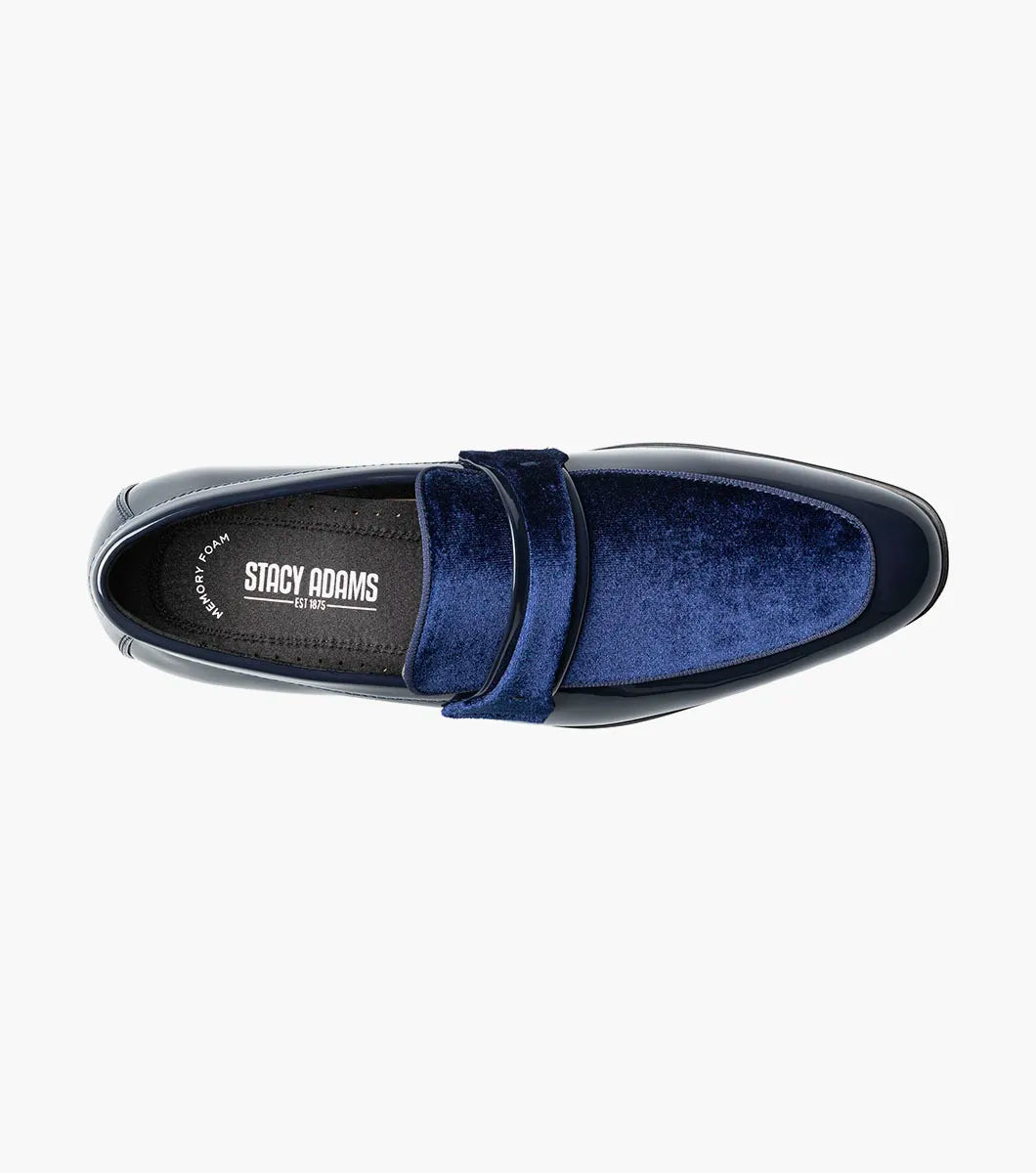 The Stacy Adams Spratley Moc Toe Saddle Slip On (25686-410) features shiny navy blue leather, a matching velour upper, cushioned insole, and low black heel. Displayed solo on a white background.