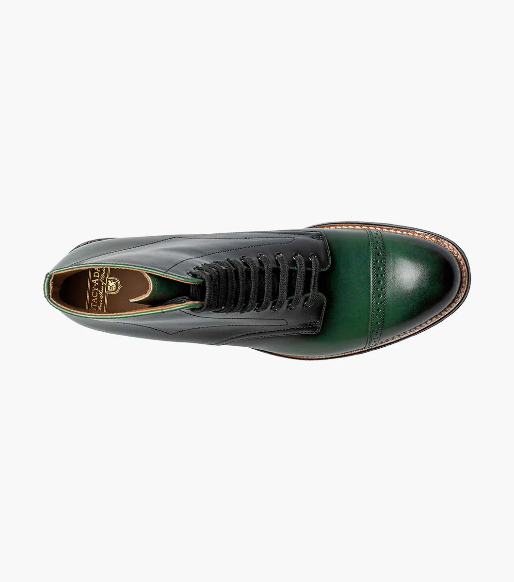 The Stacy Adams Madison Cap Toe Lace Up Boot (00110-300) features a dark green leather upper, black sole, brown welt, and closed lacing—an elegant STACY ADAMS dress boot shown on a white background.