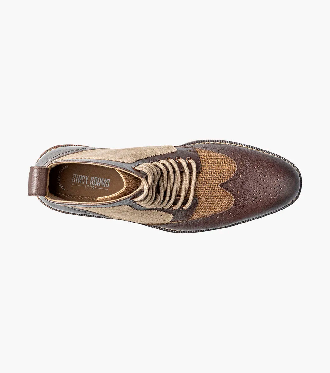 The Stacy Adams Finnegan Wingtip Lace Up Boot in Brown Tumbled (style 25427-247) features brown and tan leather suede, brogue wingtip detailing, a lace-up closure, a memory foam insole for added comfort, and a low heel, shown against a white background.