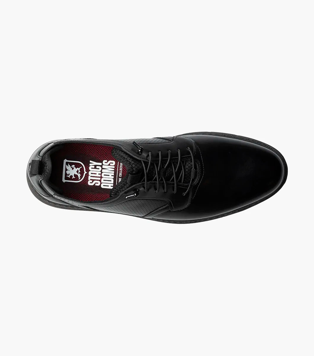 The Stacy Adams Score Plain Toe Elastic Lace Up in Black Smooth (Style 21538-005) is a black leather dress shoe featuring elastic laces, a low heel, a textured sole, and subtle perforated detailing on the side. It includes the RedZone footbed for enhanced comfort and is presented in a side profile against a white background.