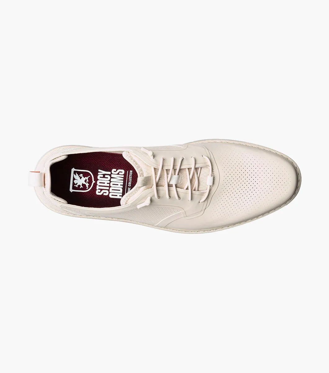 The STACY ADAMS Synchro Plain Toe Elastic Lace Up in cream (25518-113) is a leather dress shoe with perforated detailing, a gray sole, elastic laces, and a red heel pull tab, shown on a white background.