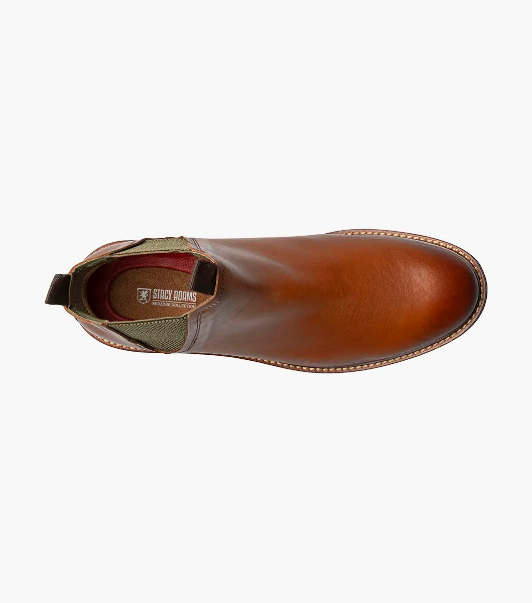 The Stacy Adams Isaacson Plain Toe Chelsea Boot in Cognac features elastic side panels, pull tabs, a low stacked heel, and a supportive leather upper—all displayed on a white background.