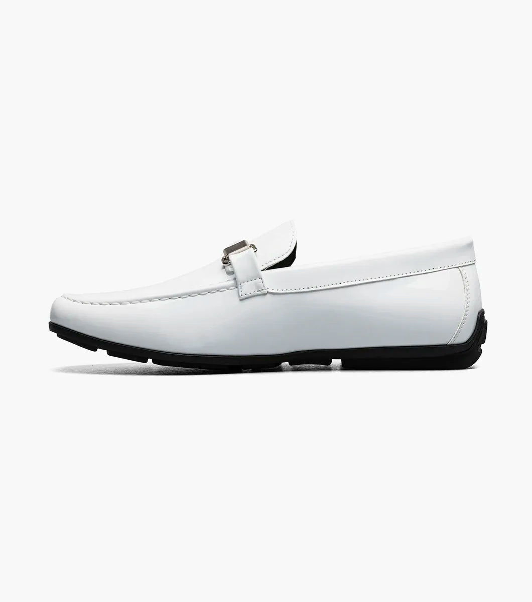 The STACY ADAMS Sheridan Moc Toe Bit Slip On (25761-122) is a white patent loafer with metal bit detail, a black sole, and visible stitching, shown on a plain white background.
