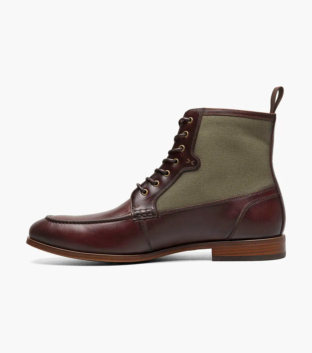 The Stacy Adams Brumley Moc Toe Lace Up Boot in Brown Multi features burnished leather and olive green fabric, a lace-up closure, cushioned footbed, and low stacked heel for lasting comfort and style.