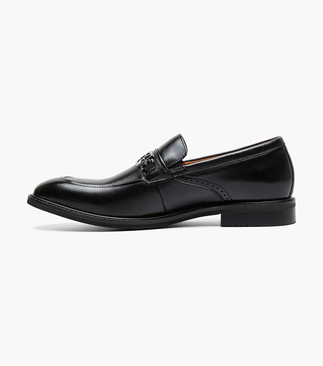 The Stacy Adams Boyd Moc Toe Bit Slip On (Black, 25753-001) features a black leather loafer design with a metal bit detail, low heel, moc toe, visible stitching, and a cushioned footbed for comfort.