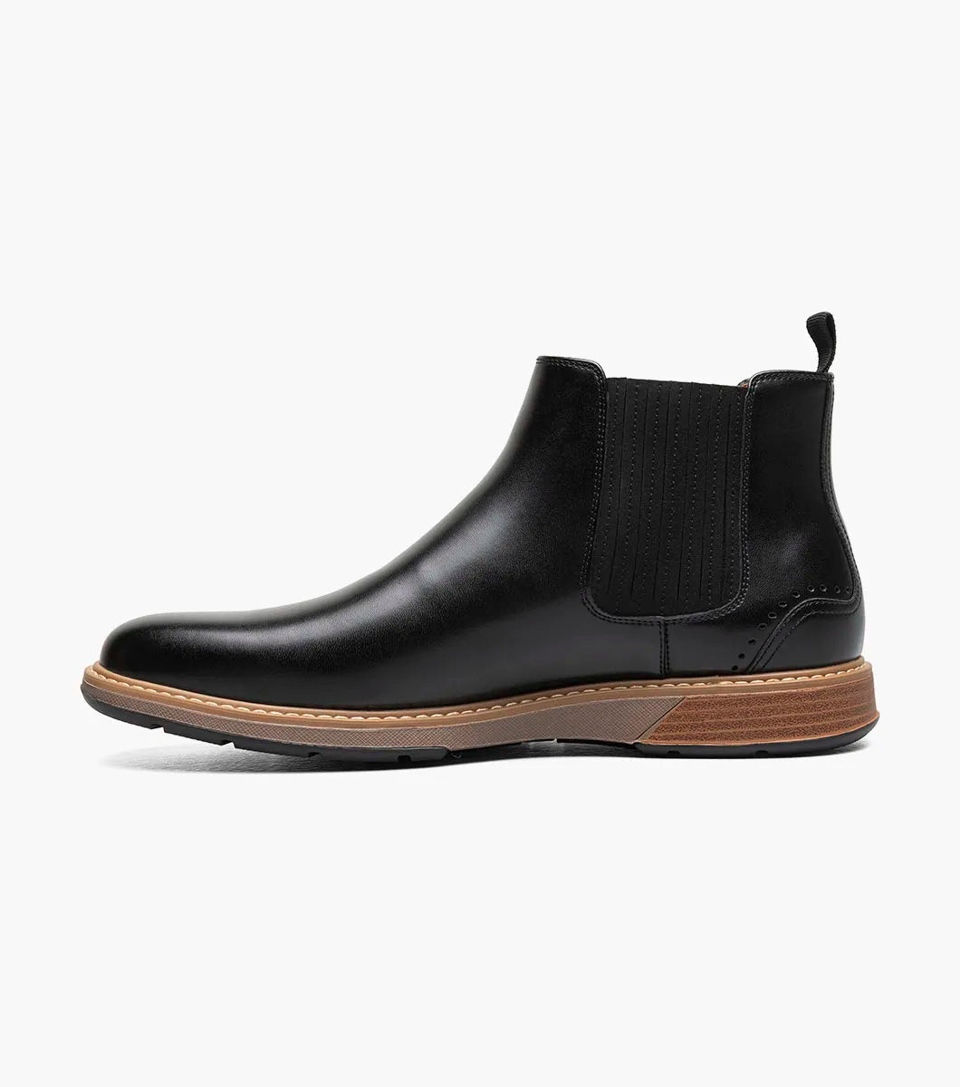 The STACY ADAMS Platt Plain Toe Chelsea Boot (Black, 25755-001) features sleek leather, elastic side panels, a brown sole, and a back pull tab—an elegant choice for any men’s boot collection.
