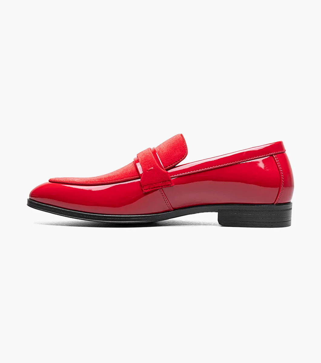 The Stacy Adams Spratley Moc Toe Saddle Slip On in red features a velour upper, matte strap, and black sole. This single shiny loafer (25686-600) by STACY ADAMS is displayed on a white background.
